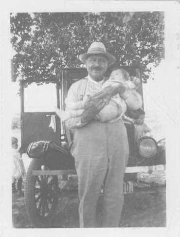 Orson Pratt Brown holding his son Aaron, Pauly and Bertha on either side, c. 1928
